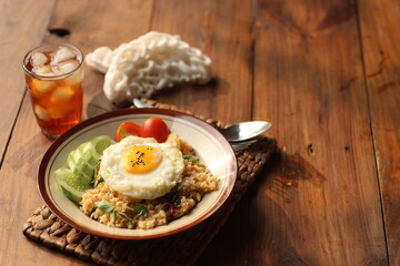 Fried Rice or Nasi Goreng with cucumber, tomato and agg. Selective focus