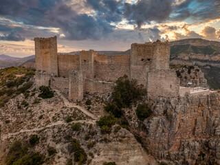 Aerial view of 15th century medieval castle ruin Castillo de Chirel in Spain above the Jucar river with partially restored walls and towers, great hiking place