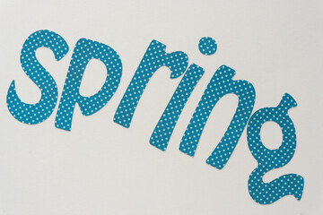 decorative blue paper with dots sign with word spring