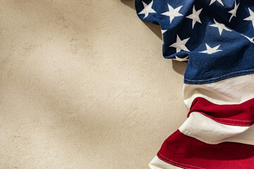 American Flag Draped Over a Textured Surface Symbolizing Patriotism and National Pride