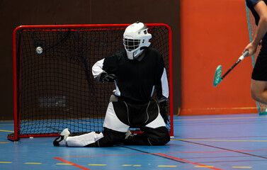 Floorball goalie against another team opponent during an important floorball championship game