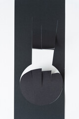 abstract machine-cut black paper stencil with keyhole form and cut flaps