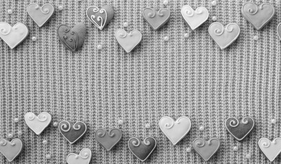 Heart-Shaped Cookies on a Sweater Textile. Love decoration. Valentine's Day background. View from...