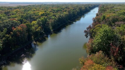 Boat traveling through green landscape with Seneca River in up state New York at Montezuma Wildlife Refuge