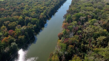 Fototapeta na wymiar Peaceful Seneca River flows through green landscape at Montezuma Wildlife Refuge in up state New York