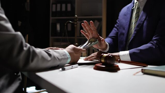 Honest officials or lawyers do not accept and refuse to accept bribes. Anonymous businessman in the dark tries to bribe official or lawyer.