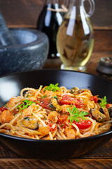 Seafood pasta with clams, salmon and tomatoes. Spaghetti with seafood cocktail