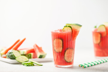 Refreshing cold summer drink watermelon slushie  with cucumber slices in glass