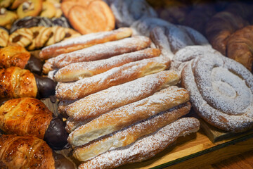 A variety of powdered and glazed pastries on display.