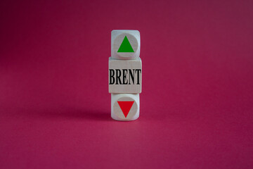 A wooden cubes with up arrow. Wooden block with the concept word BRENT . Beautiful red background....