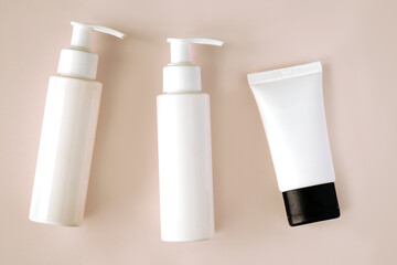 White bottles and tube of cosmetic products background