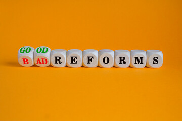 Concept red words Good reforms Bad reforms on brick blocks. Beautiful orange background. Business...