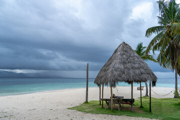 San Blas caribic island shelter hut on beautiful beach with dramatic windy weather in background at...