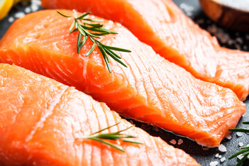 Salmon fillet, raw fresh fish with rosemary and spices. Macro image.