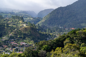 Fototapeta na wymiar Distant landscape shot of Boquete jungle canyon with houses and forest