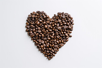 Heart shape made of coffee beans on a white background, symbolizing love for coffee
