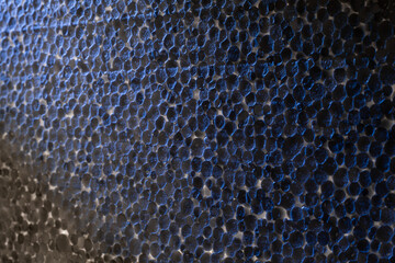 Styrofoam plate, close-up of granules, macro, illuminated by cold light.
