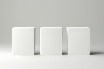 Three blank white product boxes presented on a neutral grey background.