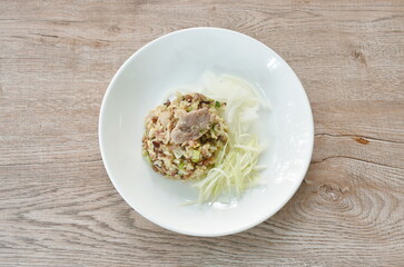 fried rice with pork topping slice onion and mango on plate 