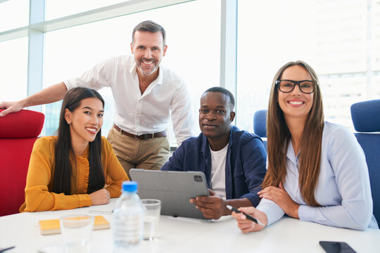 Portrait of successful business team during informal meeting at office