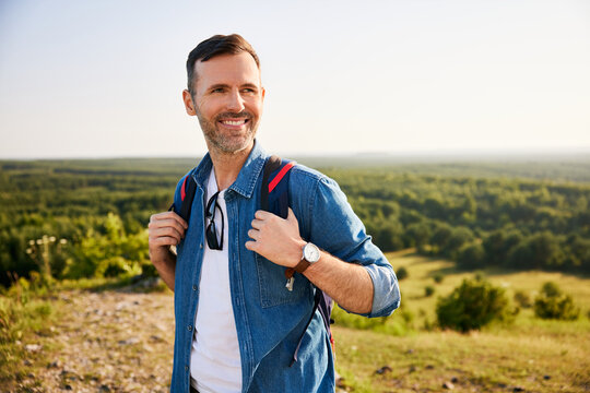 Smiling mid adult man hiking