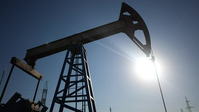 oil industry. silhouette of an oil pump extracts oil and gas from ground of the field lifestyle. business industry concept. pump pumps oil and gas at sunset. drill petroleum middle sunlight industry