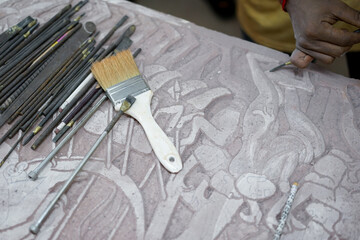 Close up on hand working on stone sculptures with all sculptures tools