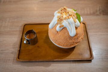 Thai Tea Kakigori close up in wooden background