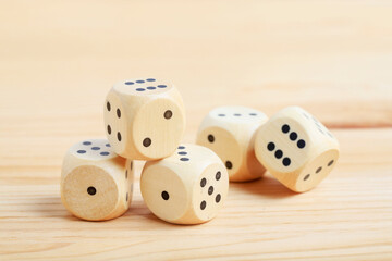 Dice cubes on wooden table, copy space.
