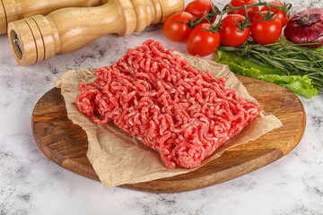 Raw minced beef meat on cutting board