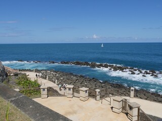 Scenic coastal view with waves rolling over the rocks behind El Morro Fort in San Juan, Puerto Rico.