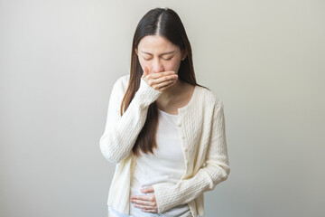 Unhappy pregnant asian young woman, pain girl suffering from nausea, having vomit feeling sick...