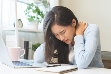 Body muscles stiff problem, ache asian young woman, girl pain neck while sitting work on chair at home, holding massaging rubbing, hurt or sore, Healthcare people, office syndrome.