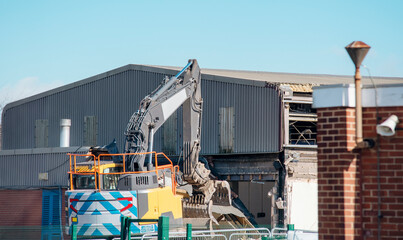 Demolition of building. Excavator breaks old house. Making space for the construction of a new houses
