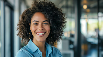 Young woman smiles with confidence in the office. - obrazy, fototapety, plakaty