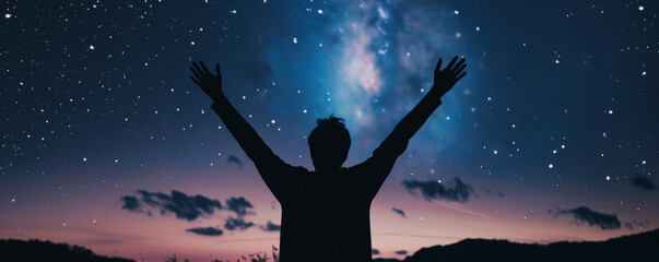 Embracing the Universe.
An individual with arms wide open embracing the expansive night sky, under the Milky Way.