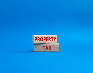 Property Tax symbol. Concept word Property Tax on wooden blocks. Beautiful blue background. Business and Property Tax concept. Copy space