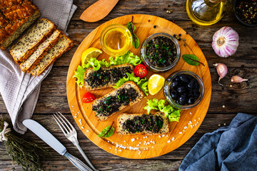 Tasty bruschetta with tapenade on wooden table
