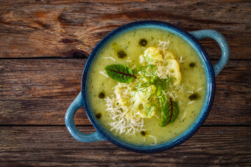 Cauliflower cream soup on wooden table
