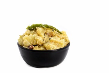 Aloo Posto or Potato Poppy Seed Gravy Cuisine in a Black Bowl Isolate on White Background with Copy Space, Indian Bengali Cuisine Dish