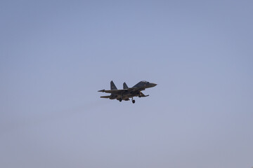 military fighter aircraft coming for landing at airfield at day