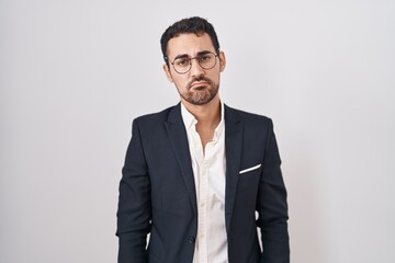 Handsome business hispanic man standing over white background depressed and worry for distress, crying angry and afraid. sad expression.