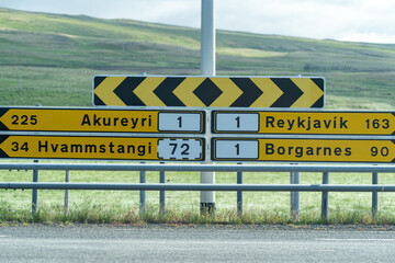 Iceland road signs giving directions along the ring road to various towns (Reykjavik, Borgarnes, Akureyri) - obrazy, fototapety, plakaty