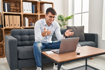 Young hispanic man psychologist having online session at psychology clinic