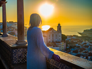 Woman standing at Santa Luzia viewpoint in Lisbon
