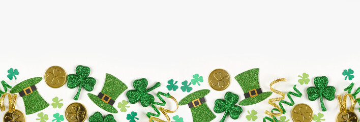 St Patricks Day bottom border of green shamrocks, leprechaun hats, gold coins and ribbon. Top down...