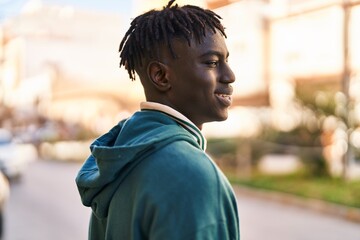 African american man smiling confident looking to the sky at street