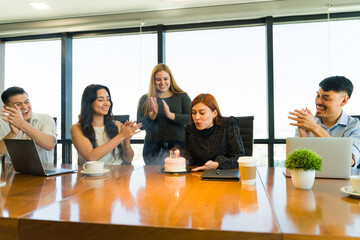 Group of workers celebrating someone's birthday at the office