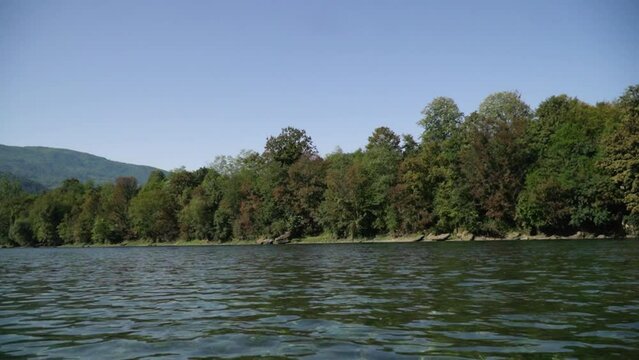 Beautiful nature footage of Drina river in Bajina Basta, edged with green bushes