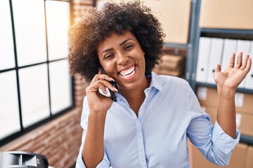 African american woman ecommerce business worker talking on smartphone at office